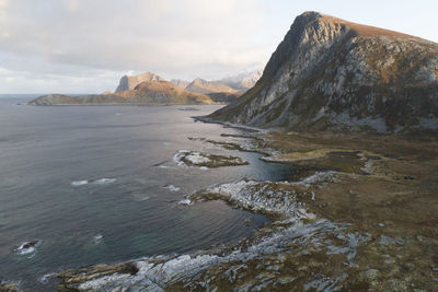 Scenic view of sea and mountains against sky