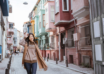 Rear view of woman standing in city