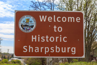 Close-up of road sign against trees