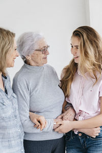 Young woman talking with mother and grandmother