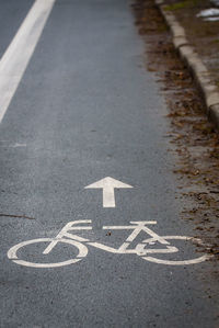 Arrow sign on road in city