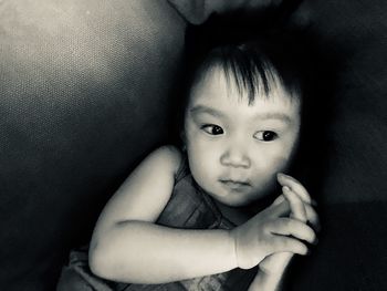 Close-up of girl lying sofa at home