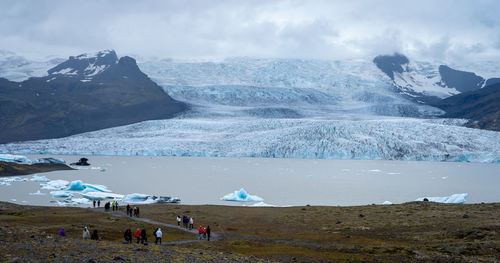 Scenic view of sea, glacier and mountains against sky