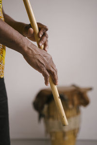 Midsection of man playing flute