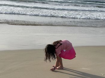 Rear view of woman walking on beach