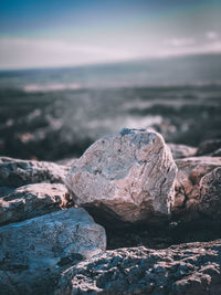 Rocks in sea against sky