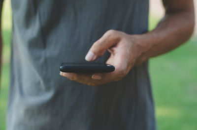 Close-up of man using mobile phone outdoors