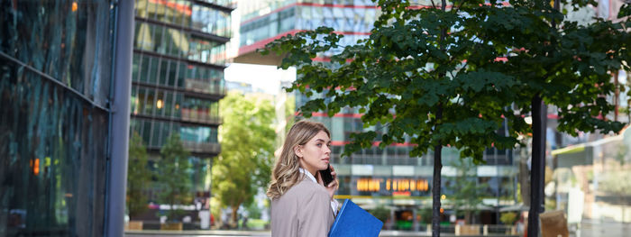 Portrait of woman standing in city