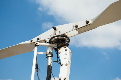 Low angle view of windmill against sky