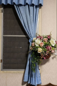 Close-up of roses against blue door