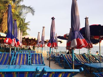 Panoramic view of flags at beach against sky