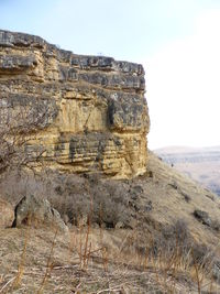 Rock formations on landscape against sky