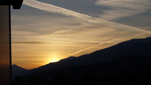 Scenic view of silhouette mountains against sky during sunset