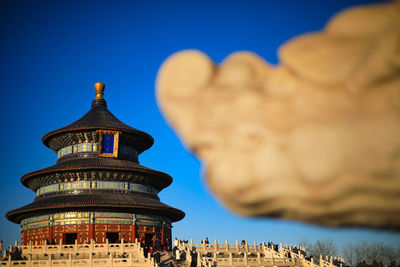 Low angle view of temple building against blue sky