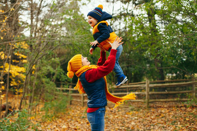 Smiling woman and son during autumn