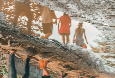 Low angle view of woman standing on rock