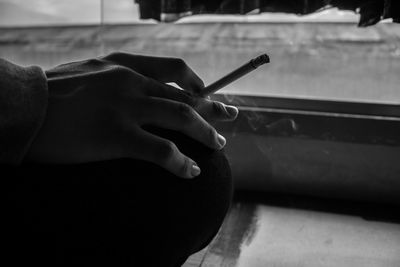 Close-up of hand holding cigarette