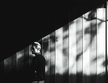 View of woman standing against wall