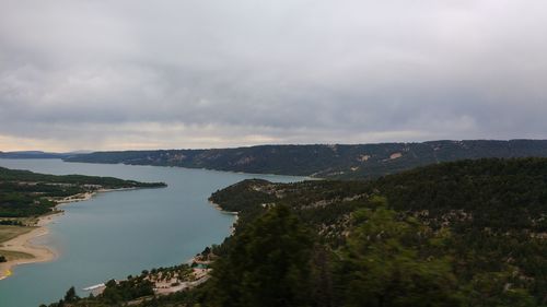 Scenic view of sea and mountains against sky