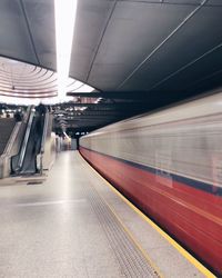Blurred motion of train at railroad station
