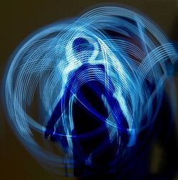 Close-up of light painting against black background