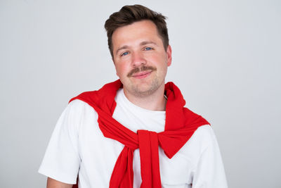 Portrait of young man against white background