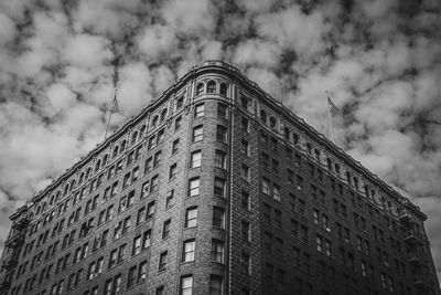 Low angle view of building against cloudy sky