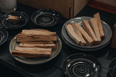 Wooden aroma organic sticks on ceramic plates. relaxation and aromatherapy concept