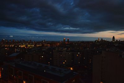 High angle view of illuminated buildings against sky at dusk