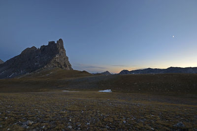 Scenic view of rocky mountains against clear blue sky