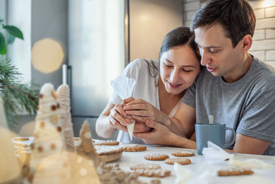 Young couple looking at food on table