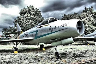 Airplane on field against sky