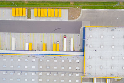 Aerial view of goods warehouse. logistics delivery center in industrial  trucks loading at logistic