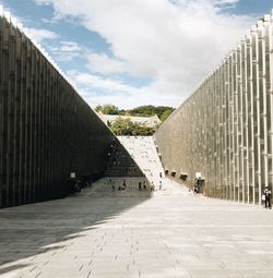 Footpath amidst buildings in city