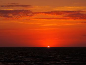 Scenic view of sea against romantic sky at sunset