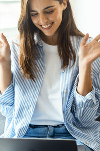 Young woman using laptop at table