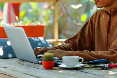 Man and coffee cup on table