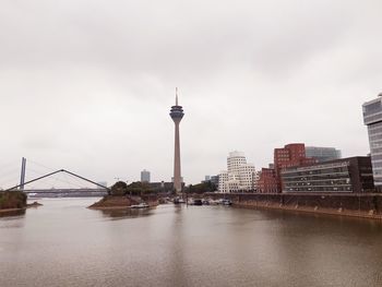 Buildings by river against sky in düsseldorf/ medienhafen 