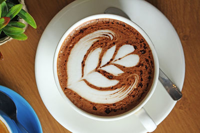 High angle view of cappuccino served on table