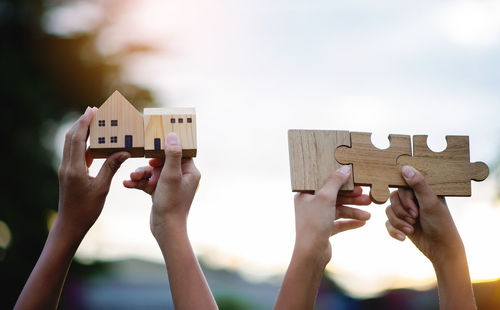 Cropped hands holding jigsaw puzzle