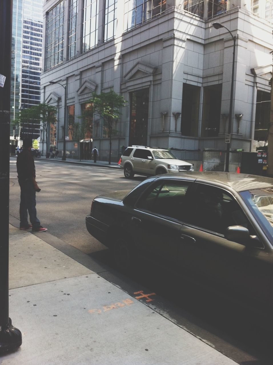 building exterior, architecture, built structure, city, transportation, street, car, mode of transport, land vehicle, city life, building, road, men, city street, incidental people, on the move, walking, day