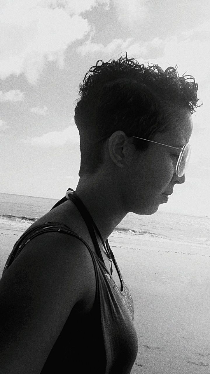 one person, sea, young adult, sky, real people, lifestyles, leisure activity, nature, portrait, headshot, beach, young men, land, water, day, glasses, side view, looking, close-up, outdoors, contemplation, profile view