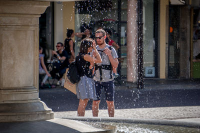 Panoramic view of people standing in city