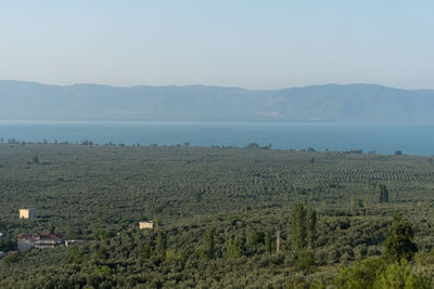 Scenic view of sea and mountains against sky