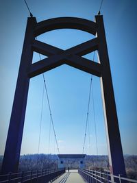 Low angle view of suspension bridge against clear sky