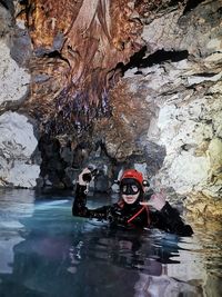 People on rock in cave