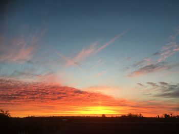 Scenic view of silhouette landscape against romantic sky at sunset