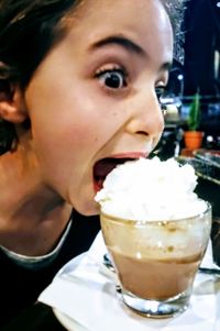 Close-up of woman with ice cream in cafe