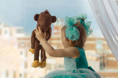 Portrait of young woman with teddy bear