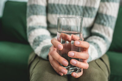 Cropped hand of woman holding wineglass